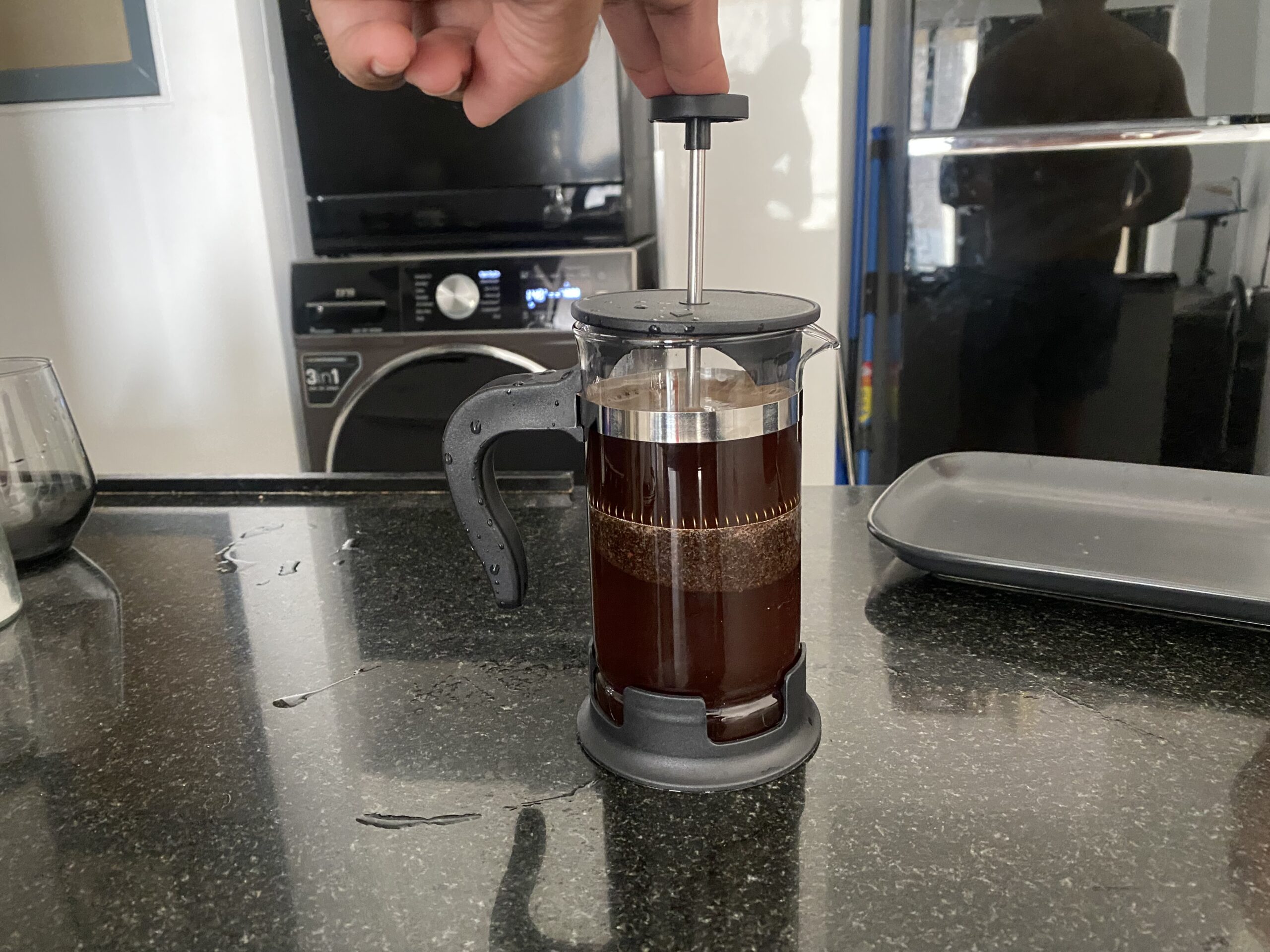 Press the plunger on coffee press